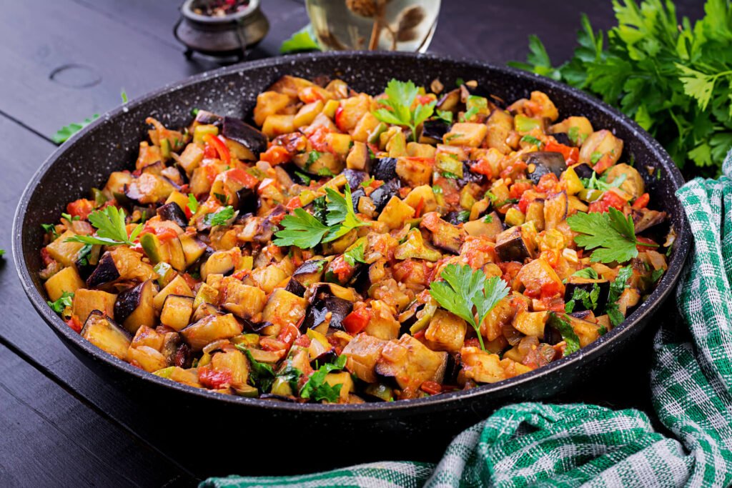 Ratatouille. Vegetarian stew eggplants, bell peppers, onions, garlic and tomatoes with herbs. Traditional french food