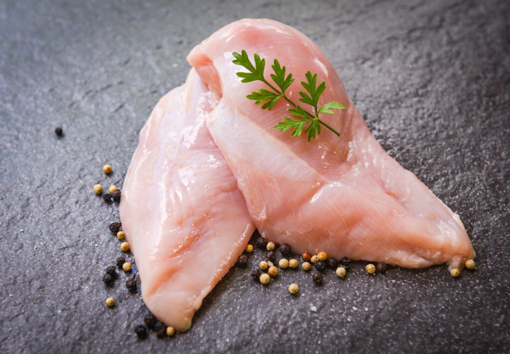 raw chicken breast with herbs and spices 