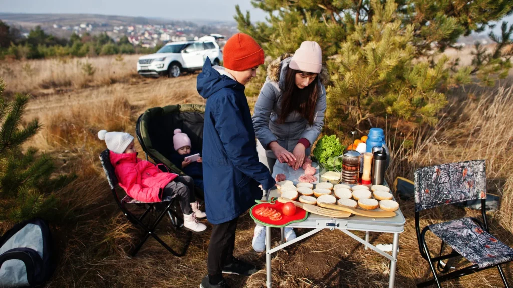 Family barbecuing on a deck in the pine forest